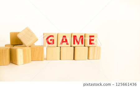 Game symbol. Concept word Game on beautiful wooden blocks. Beautiful white table white background. Business, lifestyle and game concept. Copy space. 125661436