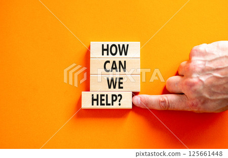 How can we help symbol. Concept words How can we help on beautiful wooden blocks. Beautiful orange table orange background. Businessman hand. Business and how can we help concept. Copy space. 125661448