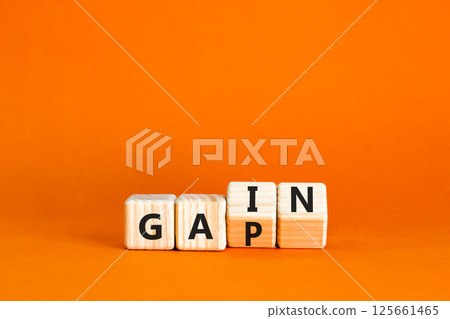 Gain or gap symbol. Concept words Gain Gap on wooden block. Beautiful orange table orange background. Business gain or gap concept. Copy space. 125661465