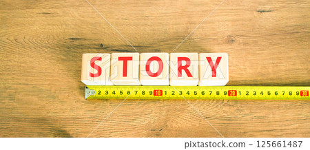 Story symbol. Concept word Story on beautiful wooden blocks. Beautiful wooden table wooden background. Beautiful yellow ruler. Business lifestyle story concept. Copy space. Story symbol. Concept word Story on beautiful wooden blocks. Beautiful wooden table wooden background. Beautiful yellow ruler. Business lifestyle story concept. Copy space. 125661487