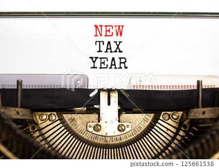 New tax year symbol. Concept words New tax year typed on beautiful old retro vintage typewriter. Beautiful white background. Business new tax year concept. Copy space. New tax year symbol. Concept words New tax year typed on beautiful old retro vintage typewriter. Beautiful white background. Business new tax year concept. Copy space. 125661538