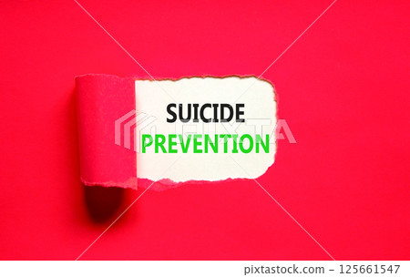 Suicide prevention symbol. Concept words Suicide prevention on beautiful white paper. Beautiful red table red background. Psychological suicide prevention concept. Copy space 125661547