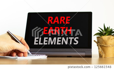 Rare earth elements symbol. Concept words Rare earth elements on beautiful black tablet. Businessman hand. Beautiful white background. Business and rare earth elements concept. Copy space. 125661548
