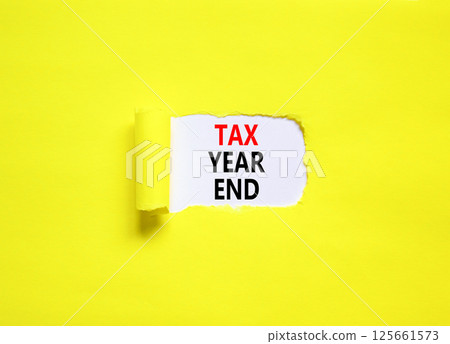 Tax year end symbol. Concept words Tax year end on beautiful white paper. Beautiful yellow table yellow background. Business tax year end concept. Copy space. Tax year end symbol. Concept words Tax year end on beautiful white paper. Beautiful yellow table yellow background. Business tax year end concept. Copy space. 125661573
