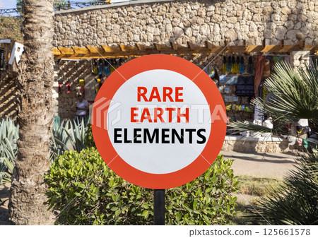 Rare earth elements symbol. Concept words Rare earth elements on beautiful big white road sign. Beautiful palm tree hotel market background. Business and rare earth elements concept. Copy space. 125661578