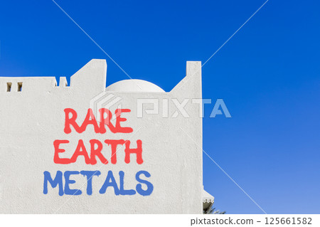 Rare earth metals symbol. Concept words Rare earth metals on beautiful white wall. Beautiful white wall blue sky background. Business and rare earth metals concept. Copy space. 125661582