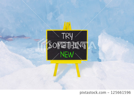 Try something new symbol. Concept words Try something new on beautiful blackboard. Beautiful blue ice and snow background. Business motivational lifestyle try something new concept. Copy space. Try something new symbol. Concept words Try something new on beautiful blackboard. Beautiful blue ice and snow background. Business motivational lifestyle try something new concept. Copy space. 125661596