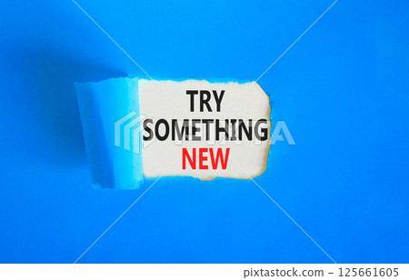 Try something new symbol. Concept words Try something new on beautiful white paper. Beautiful blue paper background. Business motivational lifestyle try something new concept. Copy space. Try something new symbol. Concept words Try something new on beautiful white paper. Beautiful blue paper background. Business motivational lifestyle try something new concept. Copy space. 125661605