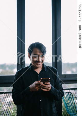 african american businessman typing message on phone african american businessman typing message on phone 125661890