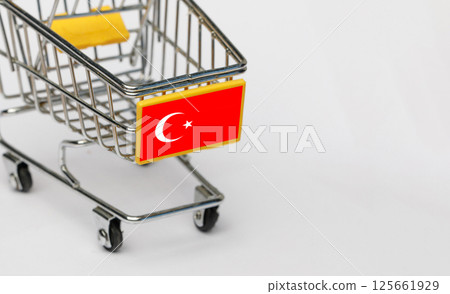 Shopping, VAT and retail in Turkey concept. Shopping Cart with Turkish flag on white background Shopping, VAT and retail in Turkey concept. Shopping Cart with Turkish flag on white background 125661929
