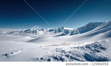 Picturesque Snow-Capped Alpine Landscape Under a Clear Blue Sky 125662058