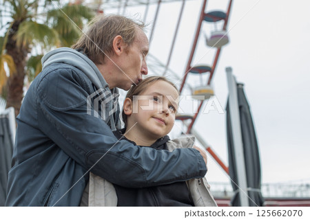 Beautiful daughter child girl and her father walking outdoors. Happiness, childhood Beautiful daughter child girl and her father walking outdoors. Happiness, childhood 125662070