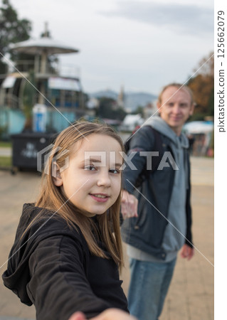 Cute daughter child girl and her father having fun. Happy family outdoors portrait. Cute daughter child girl and her father having fun. Happy family outdoors portrait. 125662079
