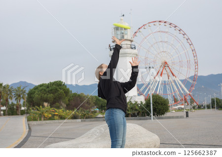 Playful child young girl throwing flying disc and having fun outdoors. Playful child young girl throwing flying disc and having fun outdoors. 125662387