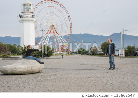 Cute daughter and father playing flying disc and having fun outdoors. Happy family, sport Cute daughter and father playing flying disc and having fun outdoors. Happy family, sport 125662547