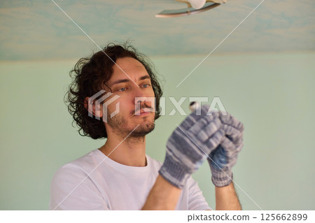 Replacing a light bulb in a home needs specific tools and techniques for safety and efficiency 125662899