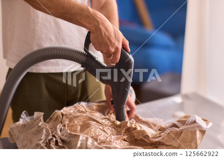 A Man Unpacking Materials in a Modern, Stylish, and Organized Kitchen Environment A Man Unpacking Materials in a Modern, Stylish, and Organized Kitchen Environment 125662922