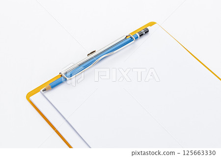 Close-up of an empty clipboard with a pencil, symbolizing a fresh start for writing, planning, or data collection. Close-up of an empty clipboard with a pencil, symbolizing a fresh start for writing, planning, or data collection. 125663330
