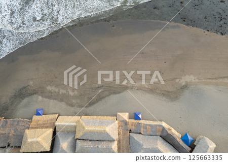 Ocean beach with canopy roofs Ocean beach with canopy roofs 125663335