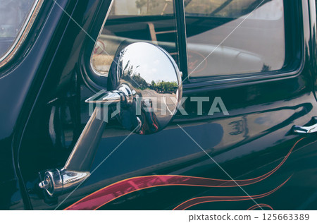 close up of classic vintage car side with rear view mirror. side mirror of a vintage car, close up of classic vintage car side with rear view mirror. side mirror of a vintage car, 125663389