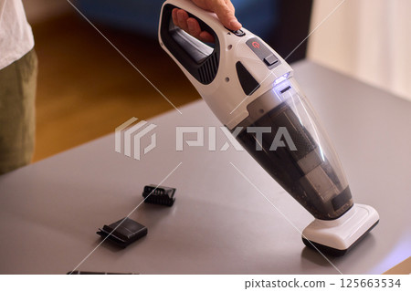 Unboxing a brand new handheld vacuum cleaner attachment, perfect for efficient cleaning tasks 125663534