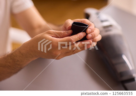 Unboxing a brand new handheld vacuum cleaner attachment, perfect for efficient cleaning tasks 125663555