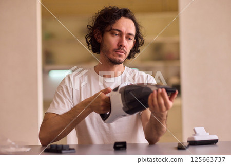 Unboxing a brand new handheld vacuum cleaner attachment, perfect for efficient cleaning tasks Unboxing a brand new handheld vacuum cleaner attachment, perfect for efficient cleaning tasks 125663737