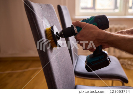 Effective Upholstery Cleaning Using a Power Tool on a Beautiful Sofa for the Best Results 125663754