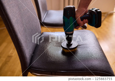 Effective Upholstery Cleaning Using a Power Tool on a Beautiful Sofa for the Best Results 125663755