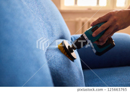 Effective Upholstery Cleaning Using a Power Tool on a Beautiful Sofa for the Best Results Effective Upholstery Cleaning Using a Power Tool on a Beautiful Sofa for the Best Results 125663765