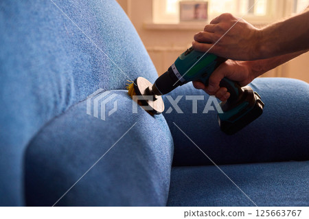 Effective Upholstery Cleaning Using a Power Tool on a Beautiful Sofa for the Best Results 125663767