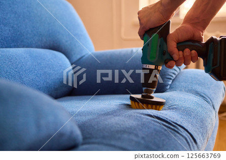 Effective Upholstery Cleaning Using a Power Tool on a Beautiful Sofa for the Best Results 125663769