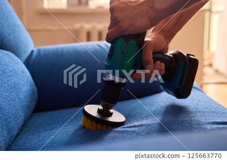 Effective Upholstery Cleaning Using a Power Tool on a Beautiful Sofa for the Best Results 125663770