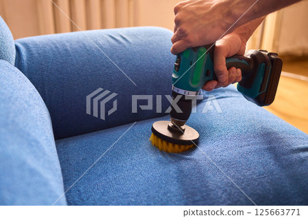 Effective Upholstery Cleaning Using a Power Tool on a Beautiful Sofa for the Best Results 125663771