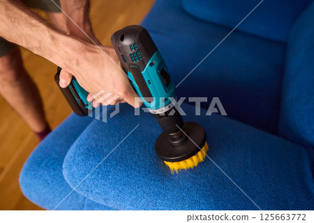 Effective Upholstery Cleaning Using a Power Tool on a Beautiful Sofa for the Best Results Effective Upholstery Cleaning Using a Power Tool on a Beautiful Sofa for the Best Results 125663772