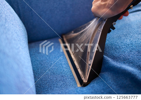 The Professional Upholstery Cleaning Process is in full action, showcasing its effectiveness 125663777