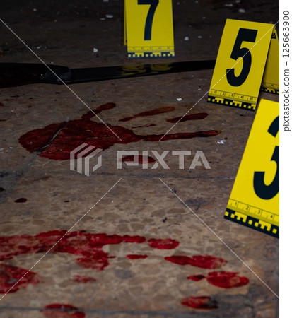 Bloody handprint and bloody knife at crime scene with yellow evidence marker Bloody handprint and bloody knife at crime scene with yellow evidence marker 125663900