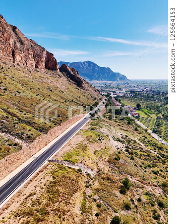 Winding road carving its way through mountainous landscape. Orihuela. Spain 125664153