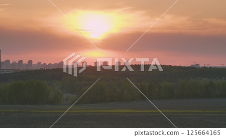 A Stunning Sunset Over the Urban Horizon, Showcasing Natures Beauty and Artistic Atmosphere 125664165