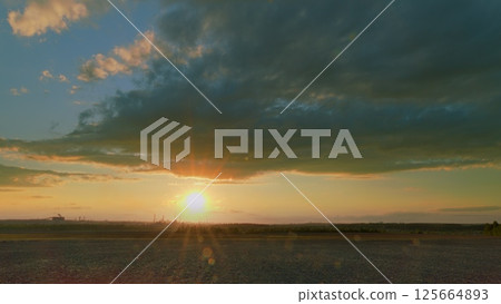 A Breathtaking and Stunning Sunset Over the Horizon, Accompanied by Dramatic and Beautiful Clouds 125664893