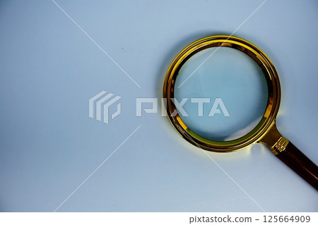 Magnifying glass with space for copy top view on blue background 125664909