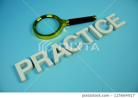 Practice alphabet letters and magnifying glass top view on blue background Practice alphabet letters and magnifying glass top view on blue background 125664917