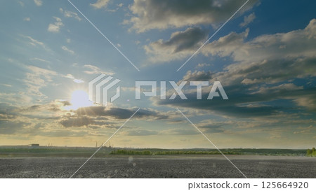 A Beautiful and Scenic Sunrise Over an Expansive Open Landscape Surrounded by Dramatic Clouds A Beautiful and Scenic Sunrise Over an Expansive Open Landscape Surrounded by Dramatic Clouds 125664920