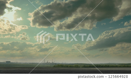 A Stunning and Beautiful Landscape Featuring Clouds Against a Vast Industrial Background 125664928