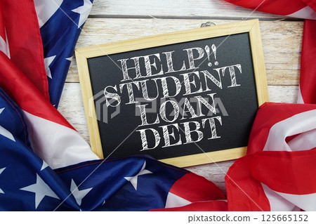 Student Loan Debt text message with USA flag on wooden background 125665152
