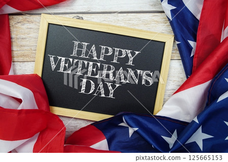 Happy Veterans Day text message with USA flag on wooden background, America national holiday concept 125665153