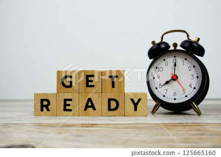 Time to Get Ready with wooden blocks alphabet letters and alarm clock on wooden background Time to Get Ready with wooden blocks alphabet letters and alarm clock on wooden background 125665160