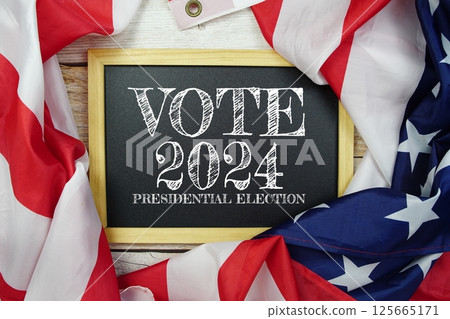 American flag with Presidential election 2024 text top view on wooden background 125665171