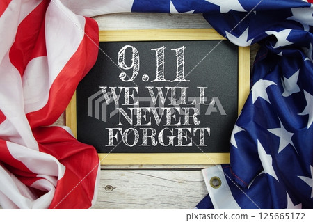 911 Patriot Day Never forget text message with USA flag on wooden background 125665172