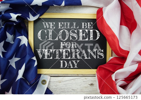 Happy Veterans Day text message with USA flag on wooden background, America national holiday concept 125665173